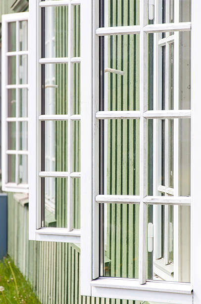 istock White wooden windows and green walls in Norway 499092865