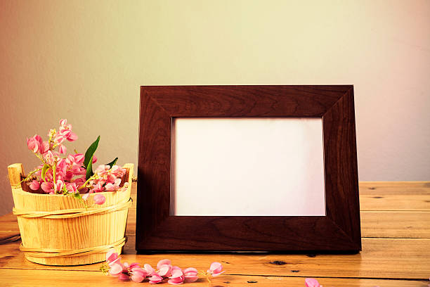 istock flowers and white photo frame on wooden table 499094134