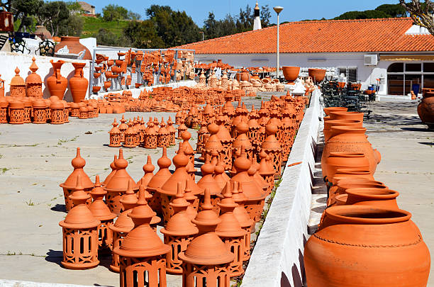 Group of large glazed clay scales for sale at pottery shop in Portugal. I took this photo at a pottery shop in the Algarve, an area in Portugal while I was there as a tourist. I like these homemade touristic objects.