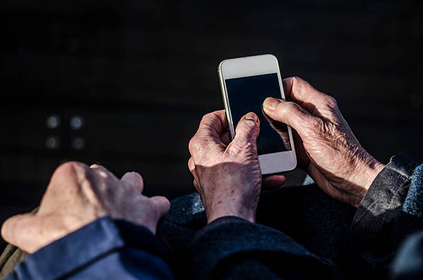 istock Old couple communicating and holding a smartphone together 499097002