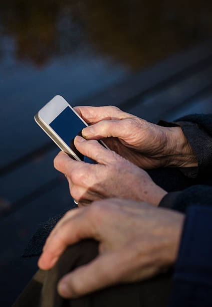 istock Old couple holding a smartphone together 499097038