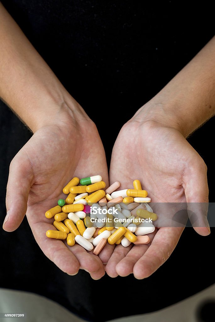 Handful of pills This is an image of a person holding a handful of multicolored pills. Acetylsalicylic Acid Stock Photo