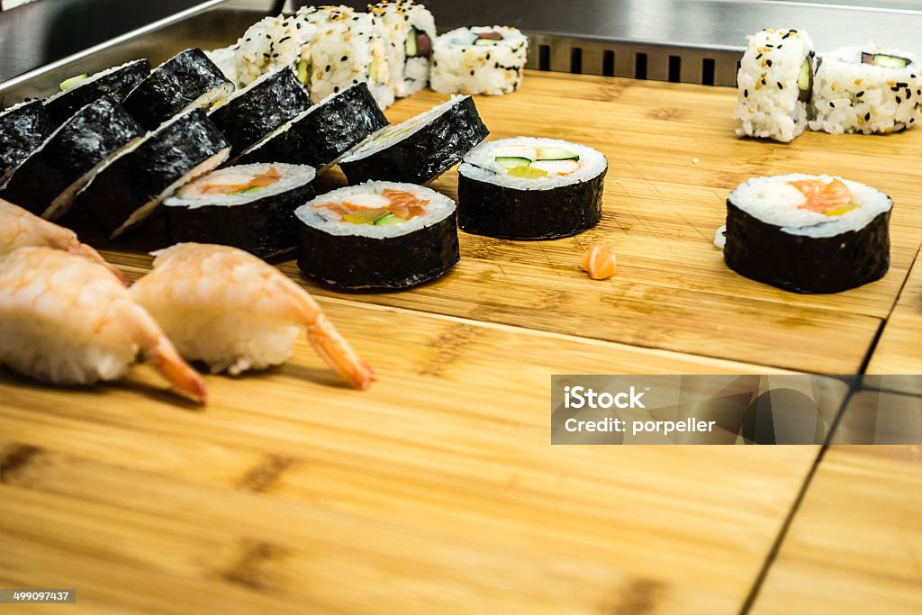 Sushi on wooden board a lot of maki sushi on a wooden board Appetizer Stock Photo