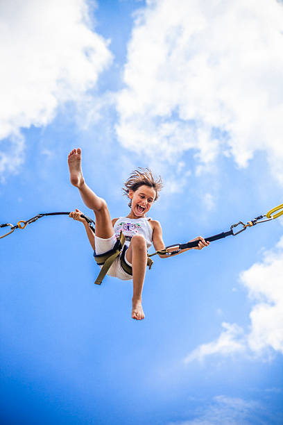 istock Little girl bungee jumping at trampoline 499097643