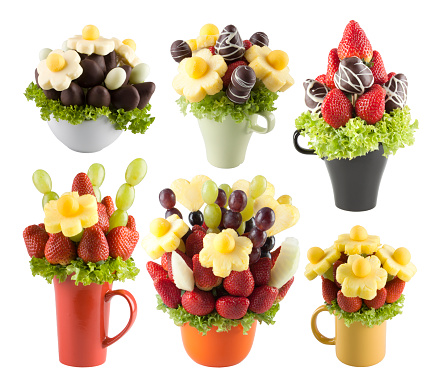 Colorful fresh fruits and chocolate on white background. Resembling a bouquet flower.