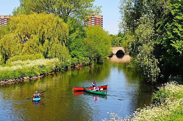 Tamworth, United Kingdom - May 17, 2014:  Three canoeists on the River Tame enjoying the sunshine, Tamworth, Staffordshire, England, UK, Western Europe.