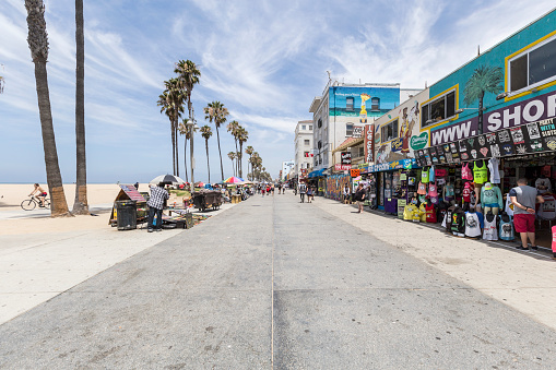 Los Angeles, California, USA - June 20, 2014:  Shops and tourists on the famously funky Venice Beach board walk in Los Angeles.  
