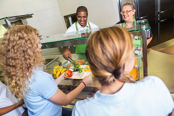 istock Students in school lunchline choosing healthy food options 499108555