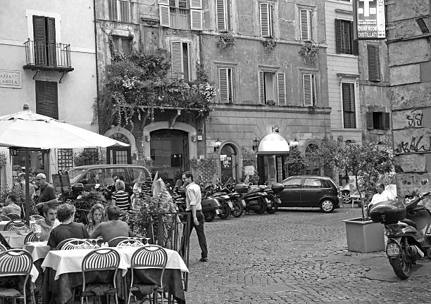 Rome, Italy - June 25, 2008: Evening summer view one of the famous restaurant on Piazza Pollarola - people communicate, relax and enjoy. 