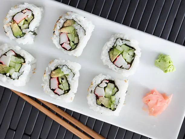 top down view a california sushi roll with wasabi and ginger.