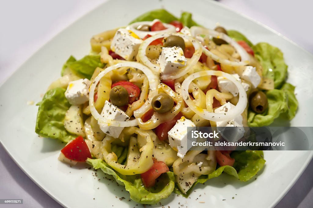 Rolled meat with French fries A healthy greek salad on table close up shot Abundance Stock Photo