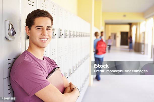 Male High School Student Standing By Lockers Stock Photo - Download Image Now - Latin American and Hispanic Ethnicity, Teenager, High School