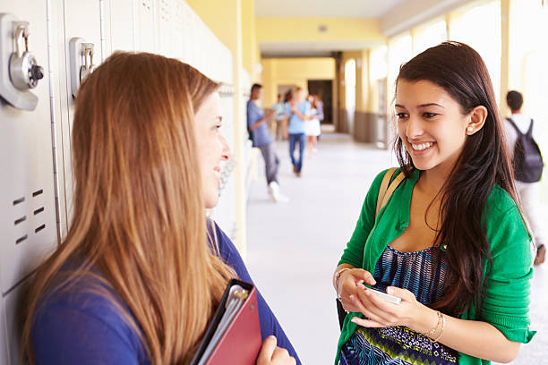 istock Two Female High School Students Talking By Lockers 499114813