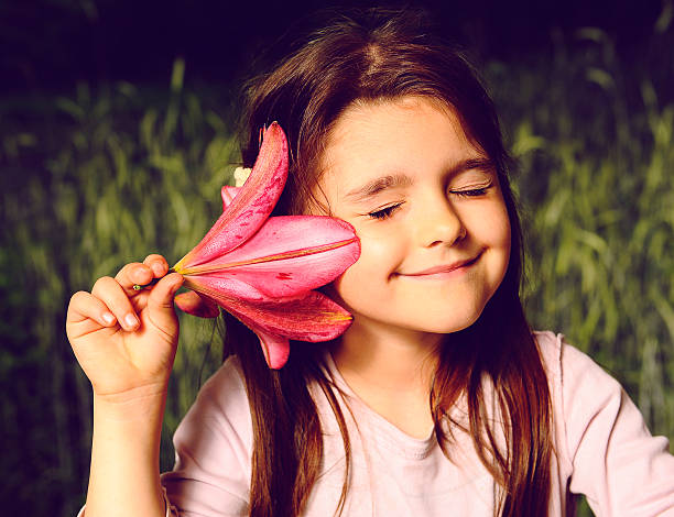 istock Girl listens to a flower (sounds of nature) 499115079