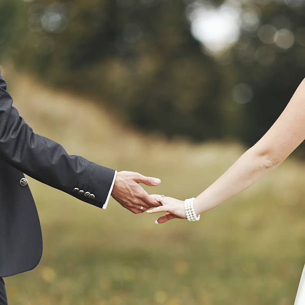 istock Groom and bride holding hands, wedding picture. 499115857