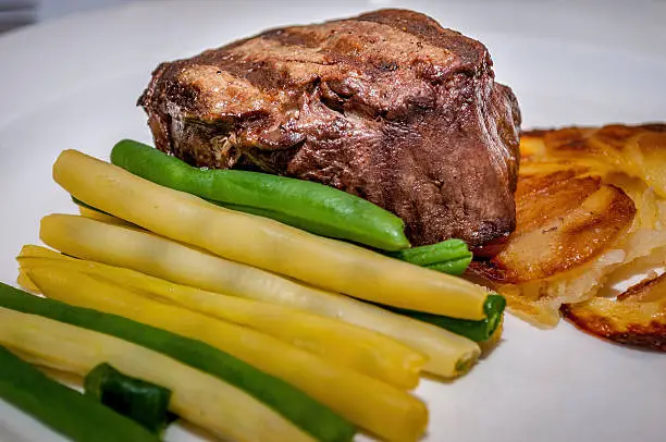 Grilled fillet steak and vegetables. Before gravy was introduced.