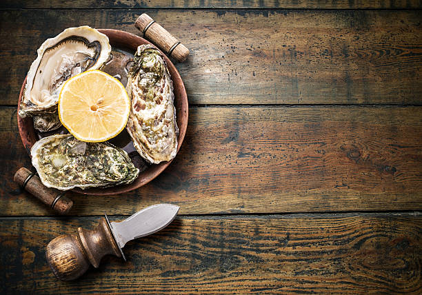 istock Raw oysters on the old wooden table. 499120622