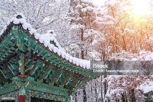 Landscape In Winter With Roof Of Gyeongbokgung And Falling Snow Stock Photo - Download Image Now