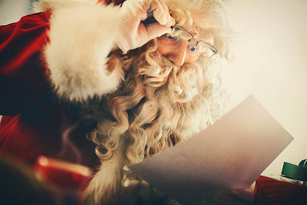 istock Santa Claus reading letters and wishlists. 499122032