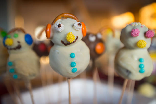 Funny homemade cake pops in the form of snowmen Funny homemade cake pops in the form of snowmen aromatisch stock pictures, royalty-free photos & images