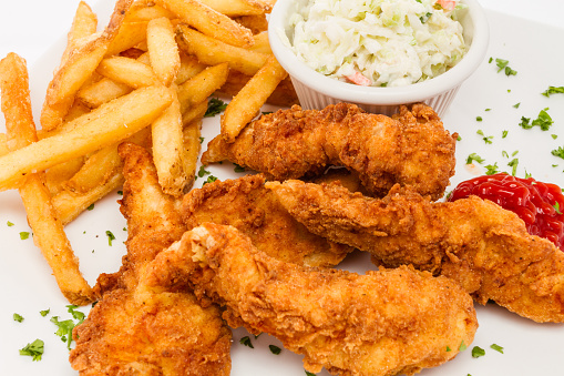 Fried chicken tenders served with french fries and cole slaw.