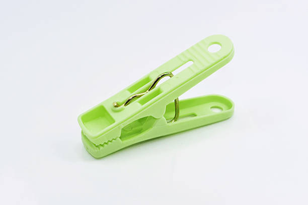 istock Plastic green clothespins isolated on white background. 499123565