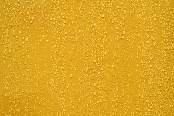 Close up water drop on orange background.