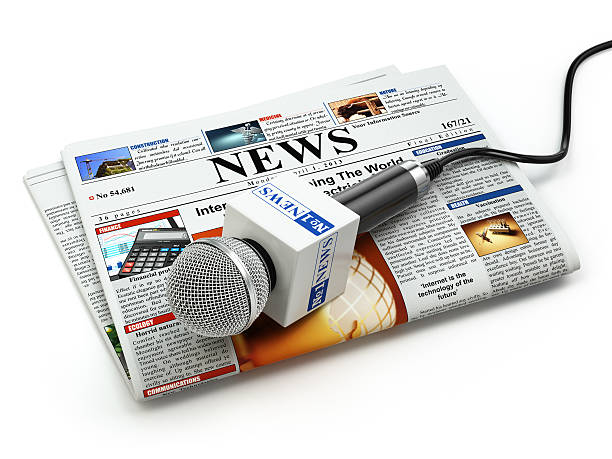 istock News or journalism concept. Microphone on the newspaper isolated 499123868