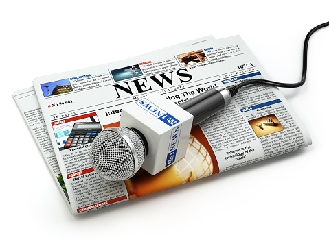 News or journalism concept. Microphone on the newspaper isolated on white. 3d