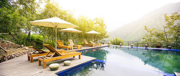 istock Umbrella chair in hotel pool resort with sunset 499124440