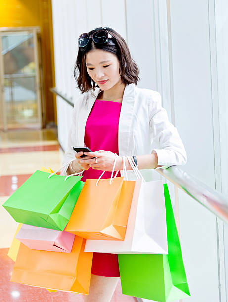 istock Young asian woman shopping and texting 499126330