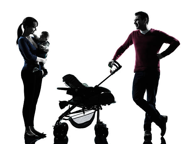 istock parents with baby silhouette 499126713