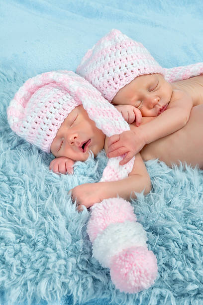 istock newborn babies with pink hats 499127059