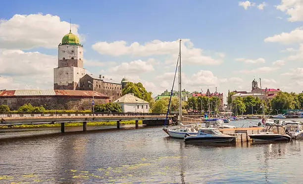 View of the ancient fortress and a pier with yachts in Vyborg