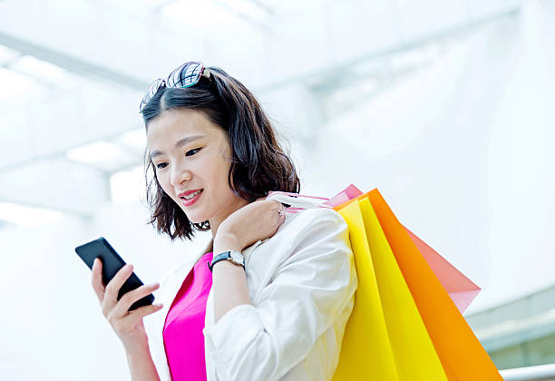 istock Young asian woman shopping and texting 499127164