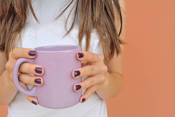 Girl with a violet mug coffee stock photo