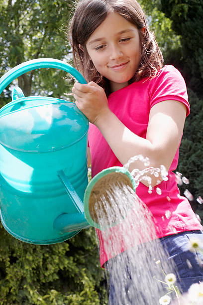 istock Girl Watering Garden 499128015