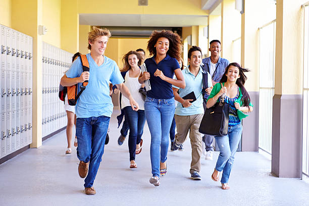 istock Group Of High School Students Running In Corridor 499128157
