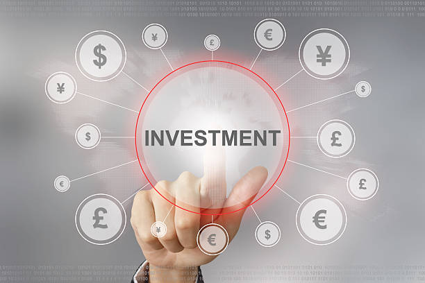 business hand pushing investment button stock photo