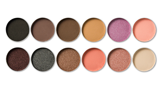 Palette of colorful eye shadows isolated on white background.