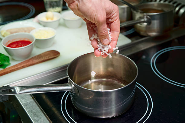istock Chef is frying onion to make risotto 499128578