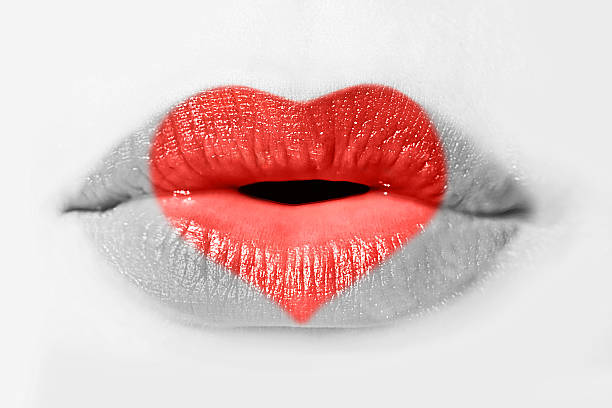 istock Red heart on woman lips isolated on white background 499128615