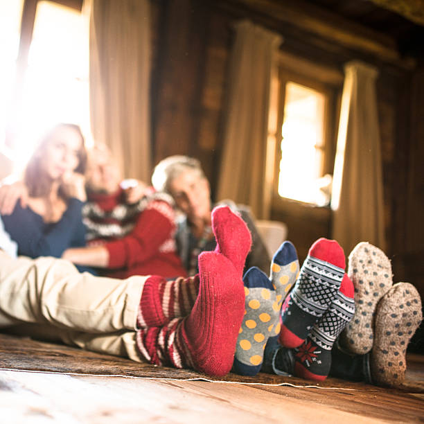 winter socks on the living room for christmas winter socks on the living room for christmas heat home interior comfortable human foot stock pictures, royalty-free photos & images