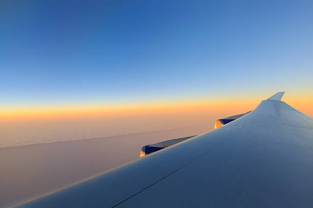 View from the airplane window above the clouds stock photo