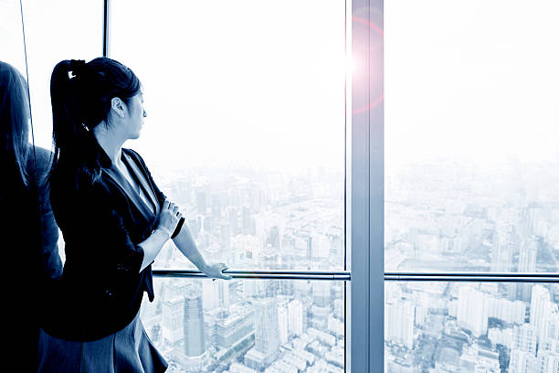 istock Businesswoman looking through the window 499129842