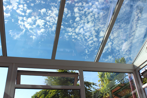 Photo showing a glass conservatory roof with panels of self-cleaning glass.  This glass is slightly tinted and has special properties, helping to reflect the outside heat in the summer and retain the interior heat in the winter.