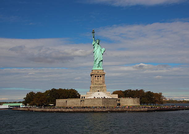 istock Liberty Island with Statue Front View and Clouds 499131150