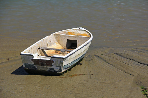 Old rowing boat on the beach at low tide