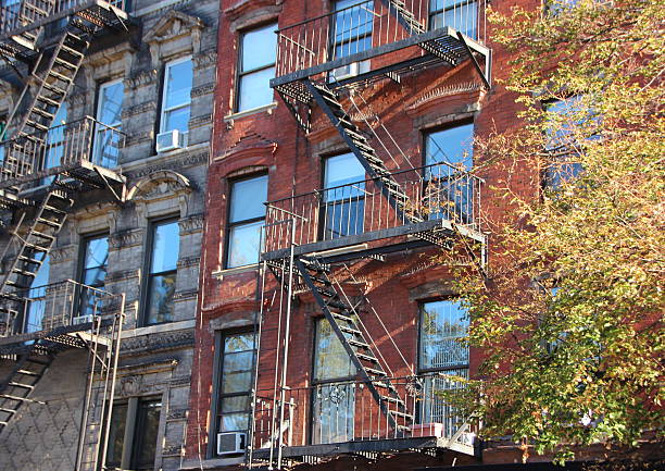 istock Perspective of Fire Escape Ladders on Apartment Building Block 499145492