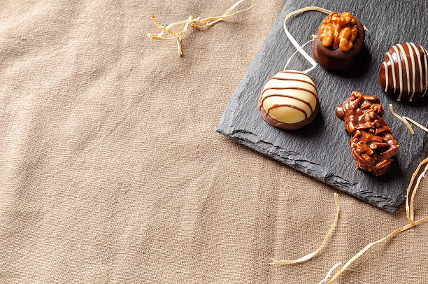 Assorted bonbons on a slate plate with straw decoration top